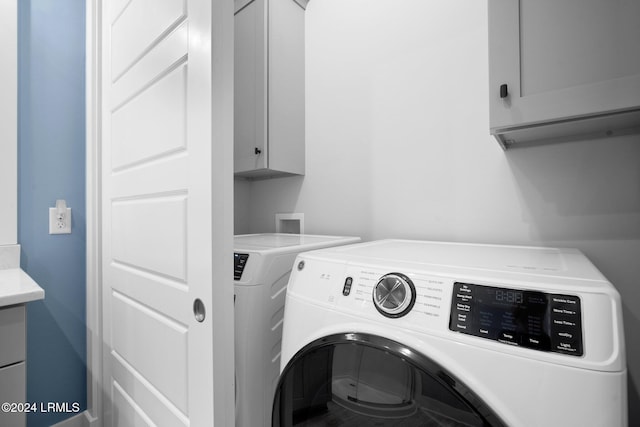 laundry area with cabinets and separate washer and dryer