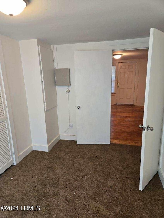 empty room with dark colored carpet