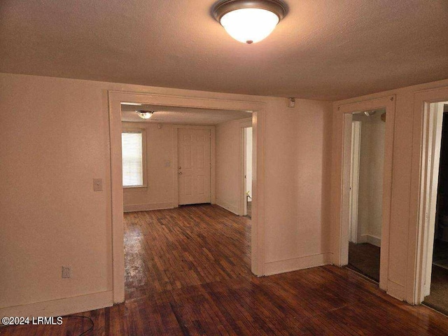 corridor featuring dark wood-type flooring