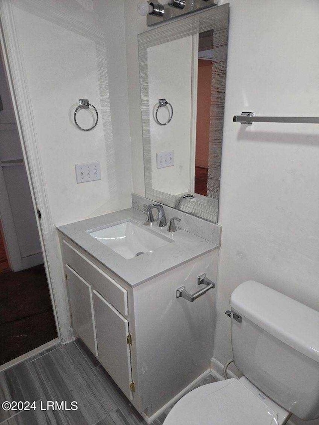 bathroom featuring vanity and toilet