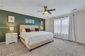 bedroom featuring ceiling fan and light carpet