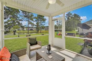 sunroom featuring ceiling fan