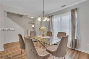 dining room featuring an inviting chandelier and wood-type flooring