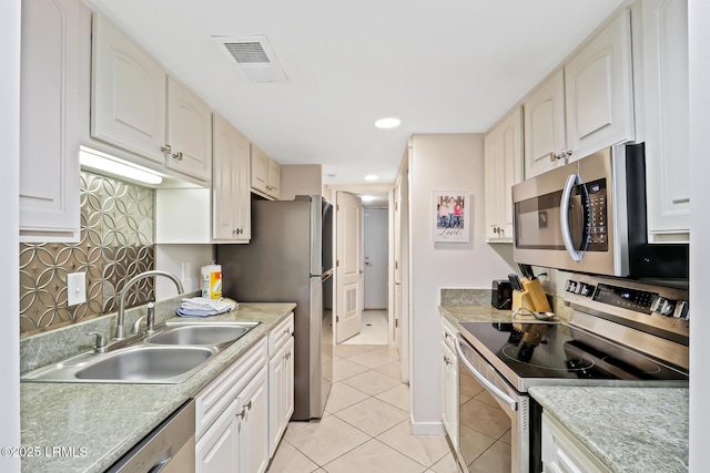 19 Stoney Creek Rd Unit 296, Hilton Head Island, SC 29928 - kitchen featuring appliances with stainless steel finishes, light tile patterned floors, light countertops, white cabinetry, and recessed lighting
