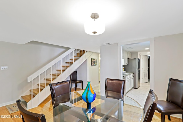 19 Stoney Creek Rd Unit 296, Hilton Head Island, SC 29928 - dining room with stairway and light wood-style flooring