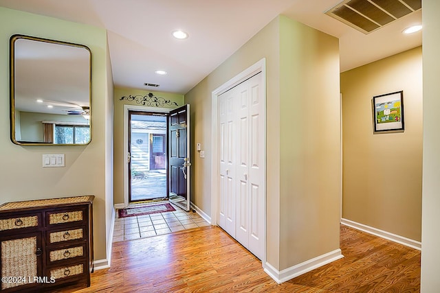 foyer with hardwood / wood-style flooring and ceiling fan