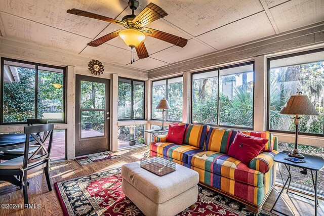 sunroom / solarium with a wealth of natural light, wooden ceiling, and ceiling fan