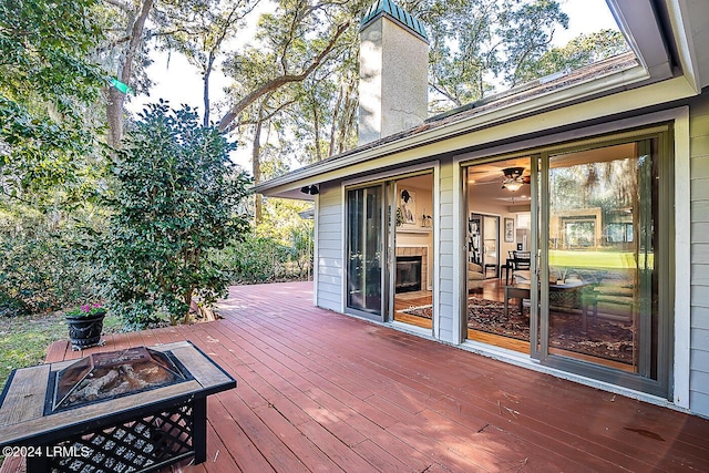 wooden deck with an outdoor fire pit