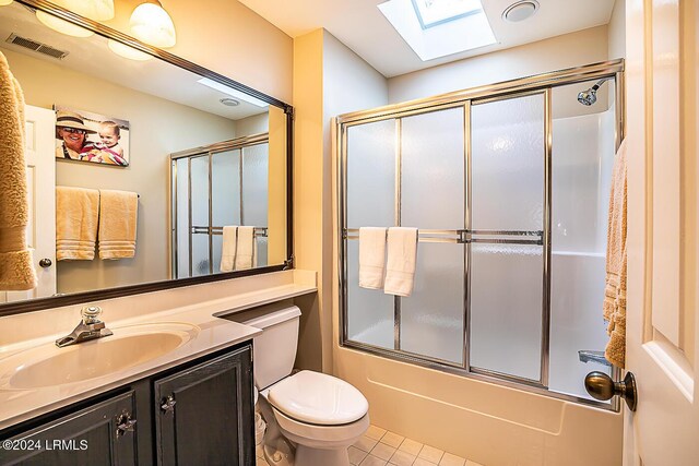 full bathroom with vanity, toilet, tile patterned flooring, and combined bath / shower with glass door