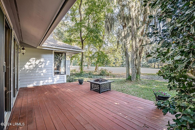 wooden terrace featuring a fire pit