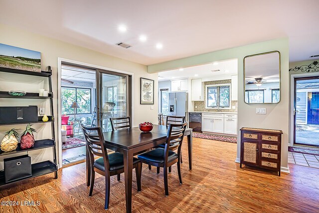 dining area featuring sink and light hardwood / wood-style flooring