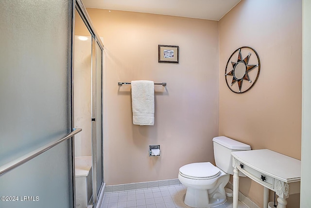 bathroom featuring an enclosed shower and toilet