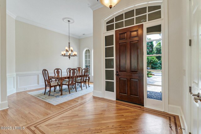 45 Manchester Ct, Bluffton, SC 29910 - entrance foyer with crown molding, a chandelier, and light wood finished floors