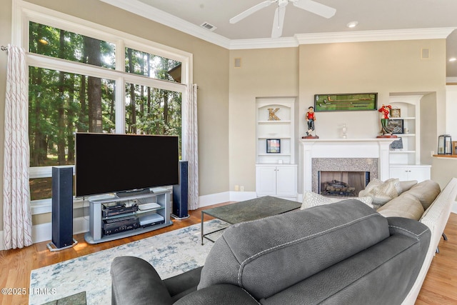 45 Manchester Ct, Bluffton, SC 29910 - living room with a ceiling fan, a fireplace, wood finished floors, ornamental molding, and built in shelves