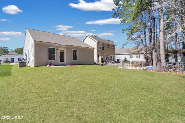580 Rudy Dr, Hardeeville, SC 29927 - rear view of house with central air condition unit, fence, and a lawn