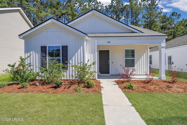 580 Rudy Dr, Hardeeville, SC 29927 - view of front of property featuring a front lawn and a porch
