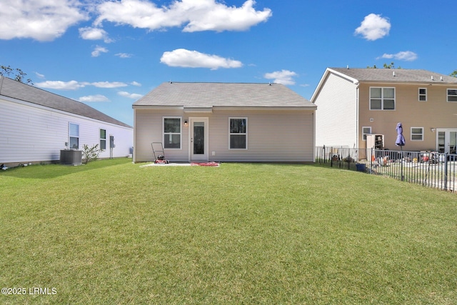 580 Rudy Dr, Hardeeville, SC 29927 - rear view of property with cooling unit, fence, and a yard