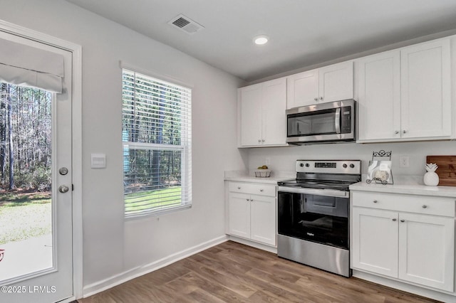 580 Rudy Dr, Hardeeville, SC 29927 - kitchen with white cabinetry, light countertops, visible vents, and stainless steel appliances