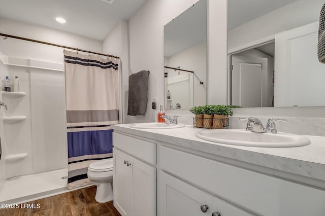 580 Rudy Dr, Hardeeville, SC 29927 - full bathroom featuring a shower stall, double vanity, wood finished floors, and a sink