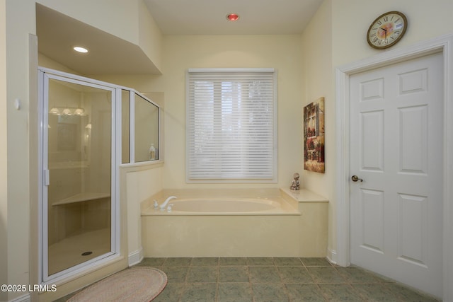 bathroom with separate shower and tub