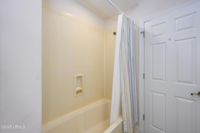 bathroom with shower / bathtub combination with curtain