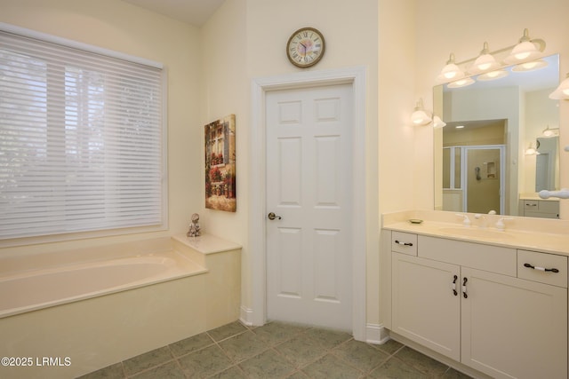 bathroom featuring tile patterned floors, shower with separate bathtub, and vanity