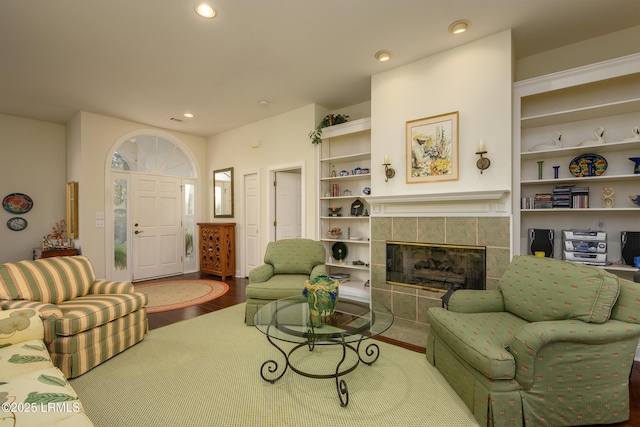 living room featuring wood-type flooring and a fireplace