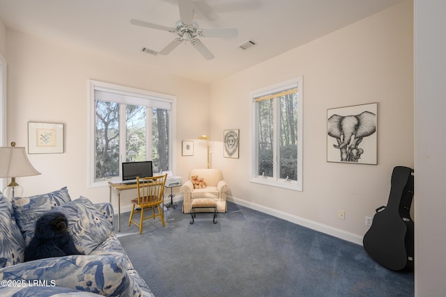 sitting room with ceiling fan and carpet floors