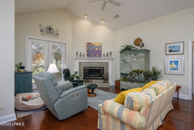 living room featuring french doors, a fireplace, dark hardwood / wood-style floors, and ceiling fan