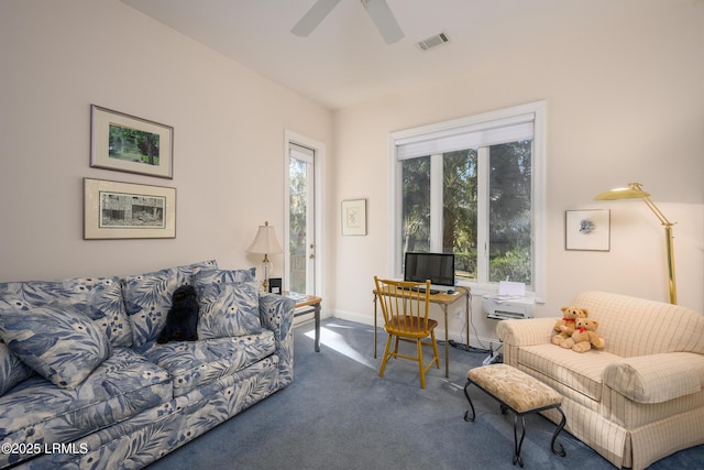 carpeted living room with ceiling fan