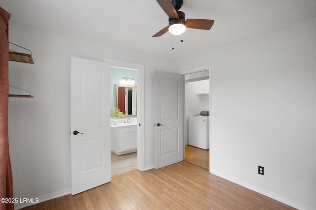 unfurnished bedroom with ceiling fan, ensuite bathroom, washer / clothes dryer, and light hardwood / wood-style floors