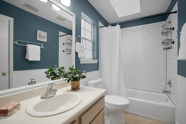 full bathroom featuring vanity, tile patterned floors, toilet, and shower / bathtub combination with curtain