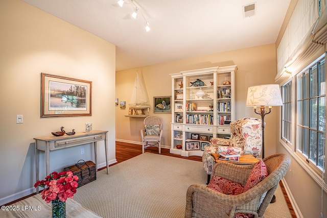459 Bb Sams Dr, Saint Helena Island, SC 29920 - living area with rail lighting, wood finished floors, and baseboards