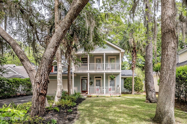 459 Bb Sams Dr, Saint Helena Island, SC 29920 - neoclassical / greek revival house with a porch, driveway, a balcony, a front yard, and an attached garage