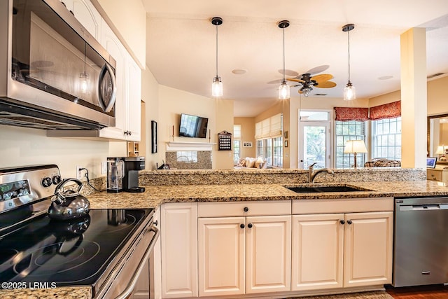 459 Bb Sams Dr, Saint Helena Island, SC 29920 - kitchen featuring light stone counters, appliances with stainless steel finishes, ceiling fan, a sink, and white cabinetry