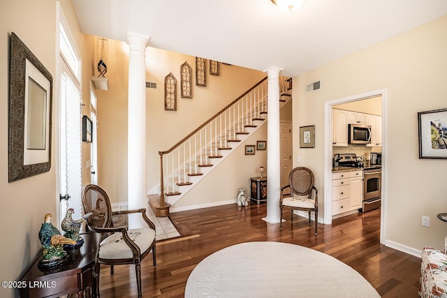459 Bb Sams Dr, Saint Helena Island, SC 29920 - foyer entrance with dark wood-style floors, ornate columns, and visible vents
