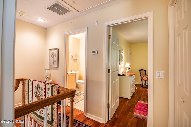 459 Bb Sams Dr, Saint Helena Island, SC 29920 - corridor featuring attic access, visible vents, and dark wood-style floors