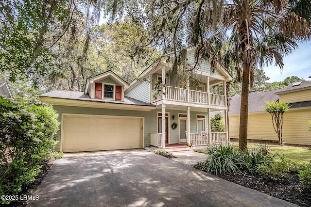 459 Bb Sams Dr, Saint Helena Island, SC 29920 - view of front facade featuring driveway, a porch, an attached garage, and a balcony