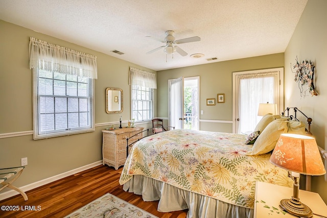 459 Bb Sams Dr, Saint Helena Island, SC 29920 - bedroom with baseboards, visible vents, a textured ceiling, and dark wood-style floors