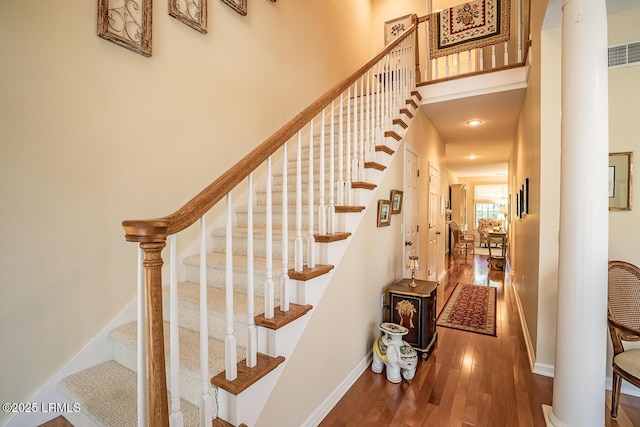 459 Bb Sams Dr, Saint Helena Island, SC 29920 - stairs featuring baseboards, ornate columns, wood finished floors, and a towering ceiling