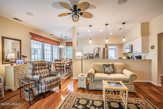 459 Bb Sams Dr, Saint Helena Island, SC 29920 - living area with baseboards, visible vents, wood finished floors, and ceiling fan