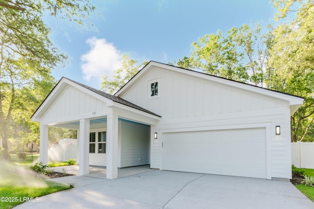 121 Joppa Rd, Beaufort, SC 29906 - modern farmhouse style home with concrete driveway, an attached garage, fence, board and batten siding, and a front yard