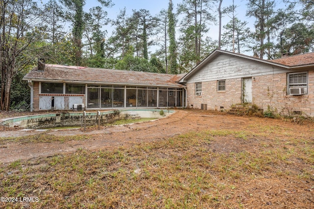 rear view of property featuring a sunroom