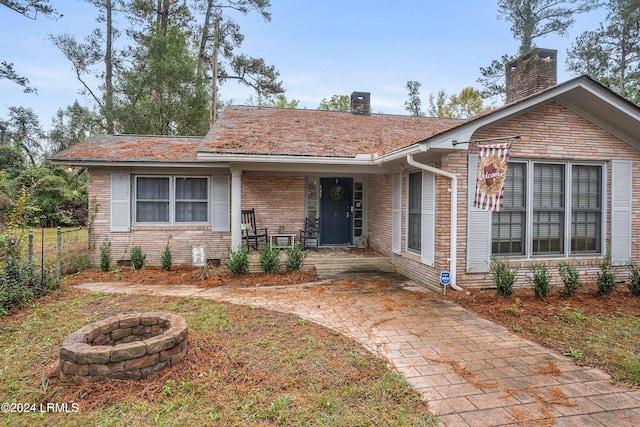 view of front facade with central AC and an outdoor fire pit