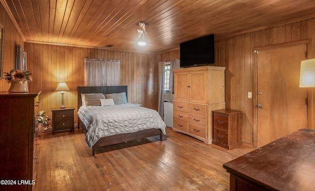 bedroom with hardwood / wood-style flooring, wooden ceiling, and wood walls