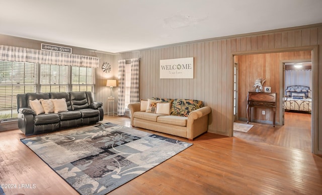 living room with hardwood / wood-style flooring, plenty of natural light, and wooden walls