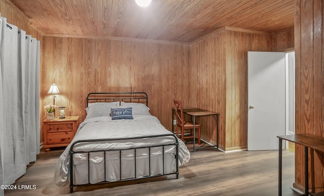 bedroom featuring wood-type flooring, wooden ceiling, and wooden walls