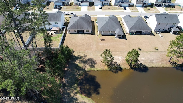 birds eye view of property featuring a residential view and a water view