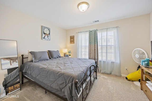 bedroom featuring baseboards, carpet floors, and visible vents