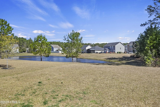 view of yard with a water view and a residential view